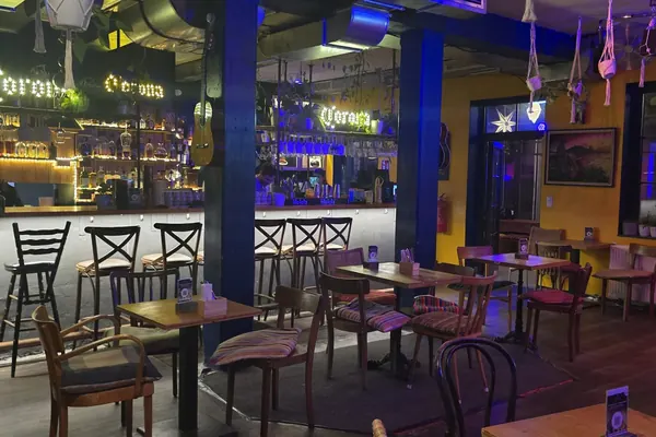 Die Bar im Mi Casa am Lend – beleuchtete Theke mit Barhockern